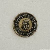 Reverse side showing numeral 5 and legend