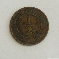 Reverse of 1908 Straits Settlements 1/2 cent coin showing denomination and date