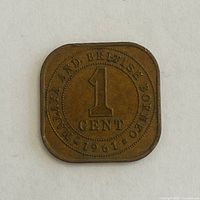 Reverse side of square 1 cent coin showing date 1961 and legend