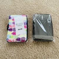 Both credit card holders; one packaged with price sticker, one wrapped