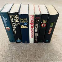 Spine view of all seven hardcover books standing upright
