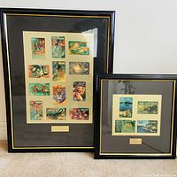 Both framed phone card sets leaning against wall