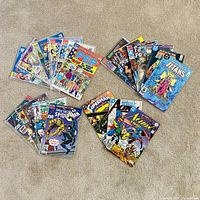 Overview of all 19 comic books arranged on carpet