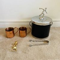 Group shot of mugs, ice bucket, opener and tongs
