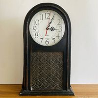 Front view of arched faux antique mantel clock
