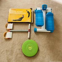 Group shot showing step machine, twister board and rowing exerciser with box