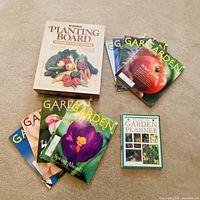 Group shot of planting board, book, and stack of magazines