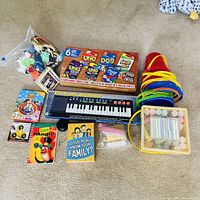 Full lot overview showing card games pack, keyboard, chalk tub, nested pails, small toys bag