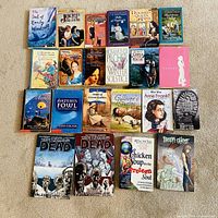All 24 books laid out on carpet