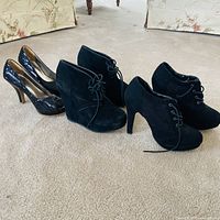All three pairs of black high heel shoes displayed together