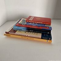 Stack of seven books showing spines and titles