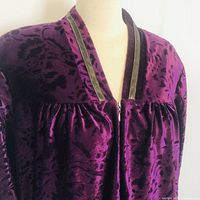 Close-up of neckline, zipper, fabric texture and trim