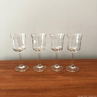 front view of four matching wine glasses