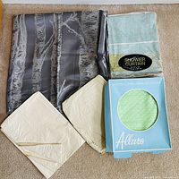 Group shot: grey patterned curtain, stripe packaged curtain, Allure box with green curtain, two cream liners