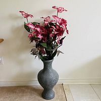 Full view of grey vase with pink silk flowers