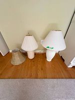 Two table lamps with shades on floor