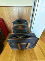 Three luggage pieces standing against wall