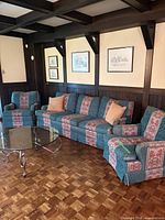Sofa flanked by two matching swivel chairs