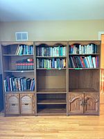 Front view of the three matching bookcase units filled with books
