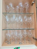 Cabinet view of three shelves of clear stemware