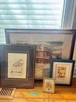 All four framed artworks grouped together on tabletop