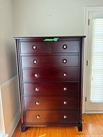 Front view of tall six-drawer dresser showing overall design and finish