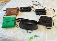 All six purses laid out with small accessory visible