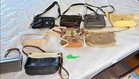 All nine purses laid out on table