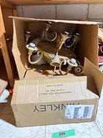 Fixture in box showing overall form and arms