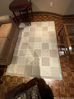 Top view of entire beige grid pattern rug