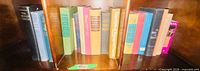 Shelf of approximately 15 hardcover books