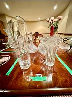 Group of crystal items on table within tape boundaries