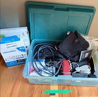 Bin with SiriusXM packaging, cables, remote and bag of accessories