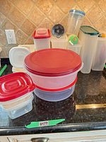 Group of containers showing various shapes, red-lidded items in front