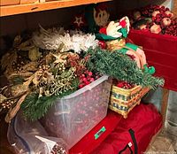 overview of bin and baskets with assorted greenery, berries, plush elf