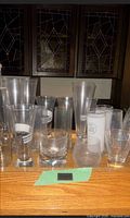 Front view of assorted glasses on wood surface