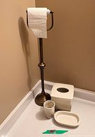 Full view of toilet paper holder with ceramic pieces