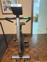 Front view of Bremshey upright exercise bike showing console, handlebars, seat and stabilizer feet