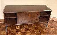 front view of cabinet showing doors, shelves and metal legs