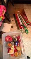 Overall lot with tote of candles and box of wrapping paper