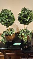 Both faux ivy topiary plants side by side showing size, pots, and foliage