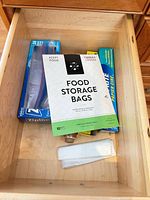 Drawer with food storage bag pack, Ziploc box, plastic wrap, wax paper, loose produce bags