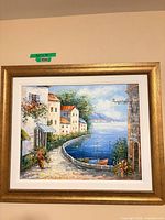 Full view of framed coastal scenic artwork on wall
