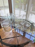 Group of clear glass vases on round table