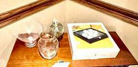 Group view of bowl, vase, lidded jar on stand, boxed tic tac toe set