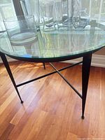 Full view of round glass table with iron base