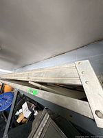 Full length view of metal ladder on storage rack