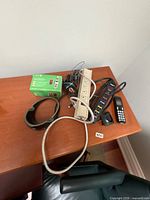 Lot overview showing two power strips, Nokia phone box, cords, Griffin dock, Panasonic handset