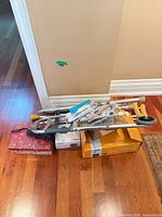 Walker folded atop boxes with crutches and mask pack visible