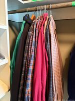 Assorted men’s shirts hanging on rail